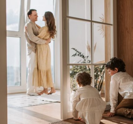 A joyful family moment indoors with parents and children enjoying a cozy home environment.