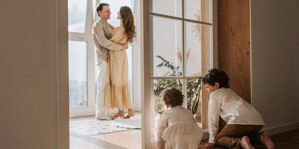A joyful family moment indoors with parents and children enjoying a cozy home environment.